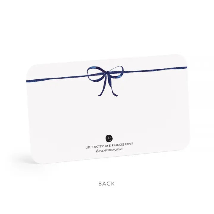E. FRANCES PAPER’s LITTLE NOTES NAVY BOW is a rectangular white mini note card with a thin hand-drawn navy border and a small bow at the top—blank inside, ideal for any boxed set of Little Notes.