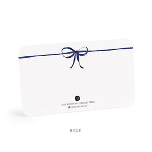 E. FRANCES PAPER’s LITTLE NOTES NAVY BOW is a rectangular white mini note card with a thin hand-drawn navy border and a small bow at the top—blank inside, ideal for any boxed set of Little Notes.