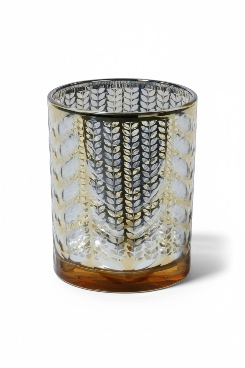 Three 4 x 5 inch LASER ETCHED METALIC HURRICANE 5″ cylindrical glass candle holders with a gold leaf pattern, each containing a lit candle.