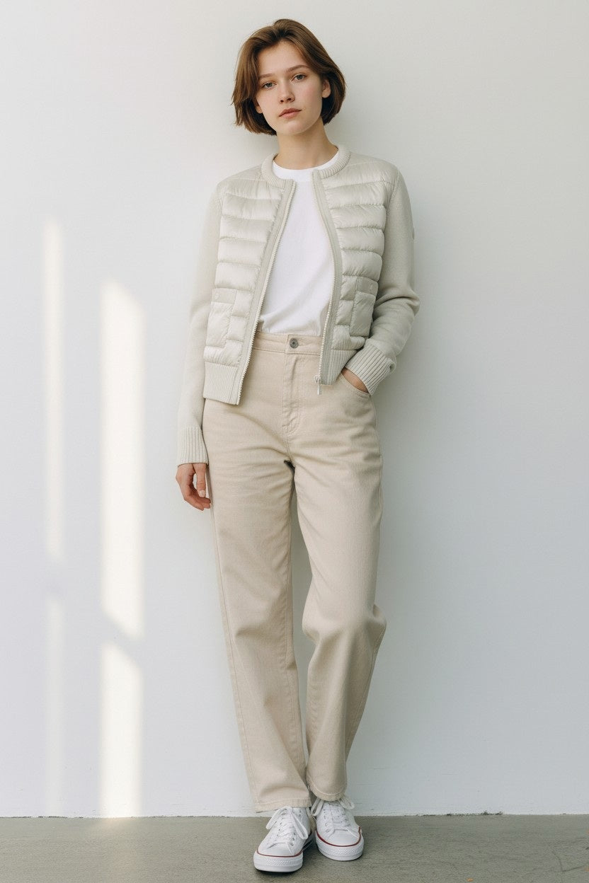 The SAVE THE DUCK BRIONY LIGHTWEIGHT PUFFER is a light gray, cropped, long-sleeve quilted jacket with padded front, ribbed cuffs and hem, two front pockets, and zip closure—ideal for summer layering. Displayed on a white background.