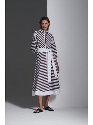 A blurry image shows the MILVA MI Cotton Poplin Dress by MILVA, featuring biscotto tan and white stripes in three horizontal bands—white at the top and bottom, and a wide tan band in the center.