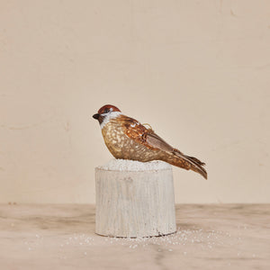 The CREATIVE COOP MERCURY GLASS BIRD ORNAMENT features brown and gray coloring, glitter bead accents, and a gold hanging string, shown isolated on a white background.