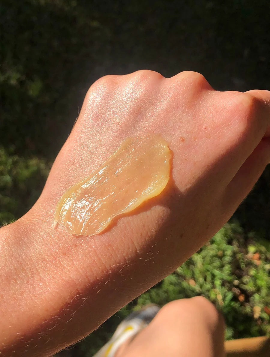 A gold tube of LANOLIPS - GOLDEN DRY SKIN MIRACLE SALVE from LANOLIPS, featuring blue text and a white cap. The label states “Made with Love and Lanolin” and describes it as an intensive hydration ointment for all-over use on dry skin.
