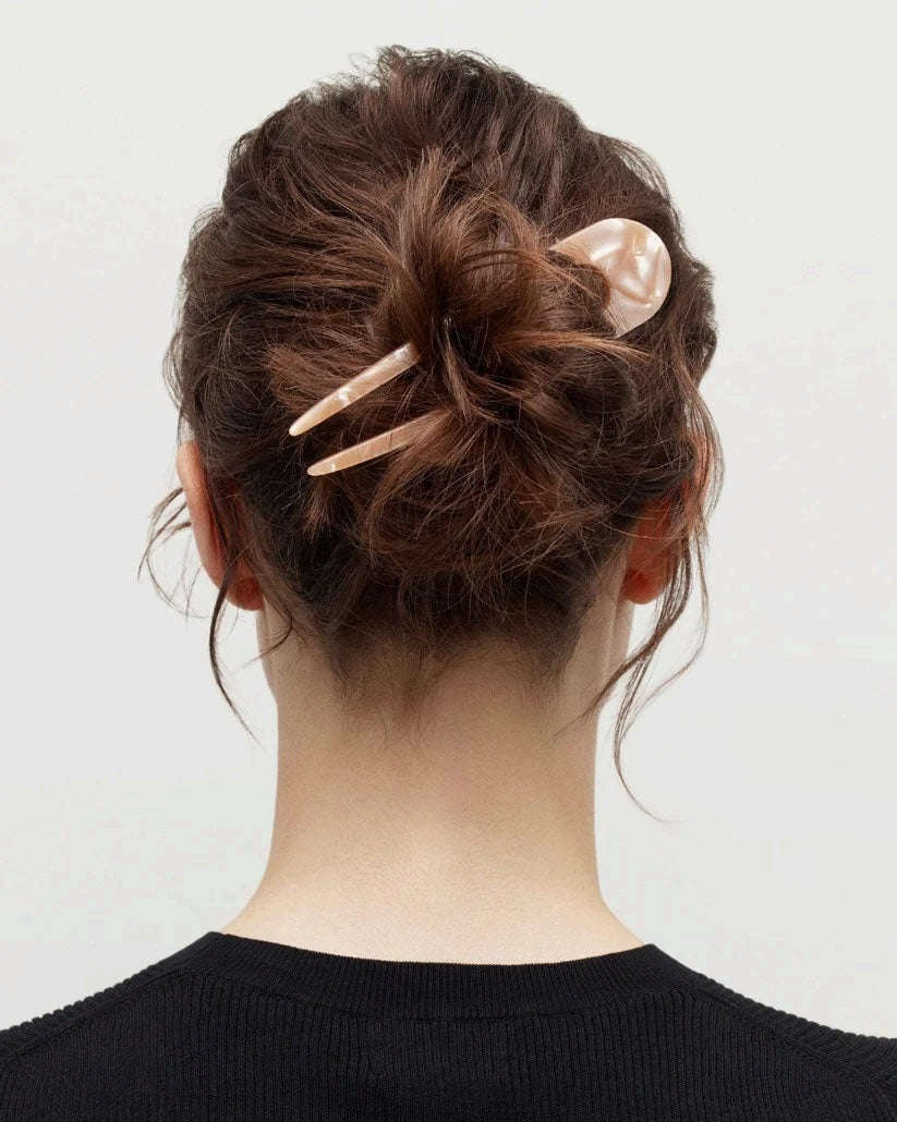 A smooth, black MACHETE - FRENCH HAIR PIN with two prongs, crafted from Italian acetate by MACHETE, rests on a plain white surface.