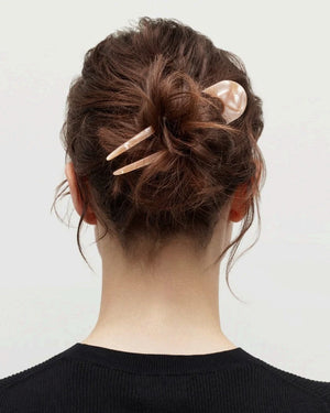 A smooth, black MACHETE - FRENCH HAIR PIN with two prongs, crafted from Italian acetate by MACHETE, rests on a plain white surface.