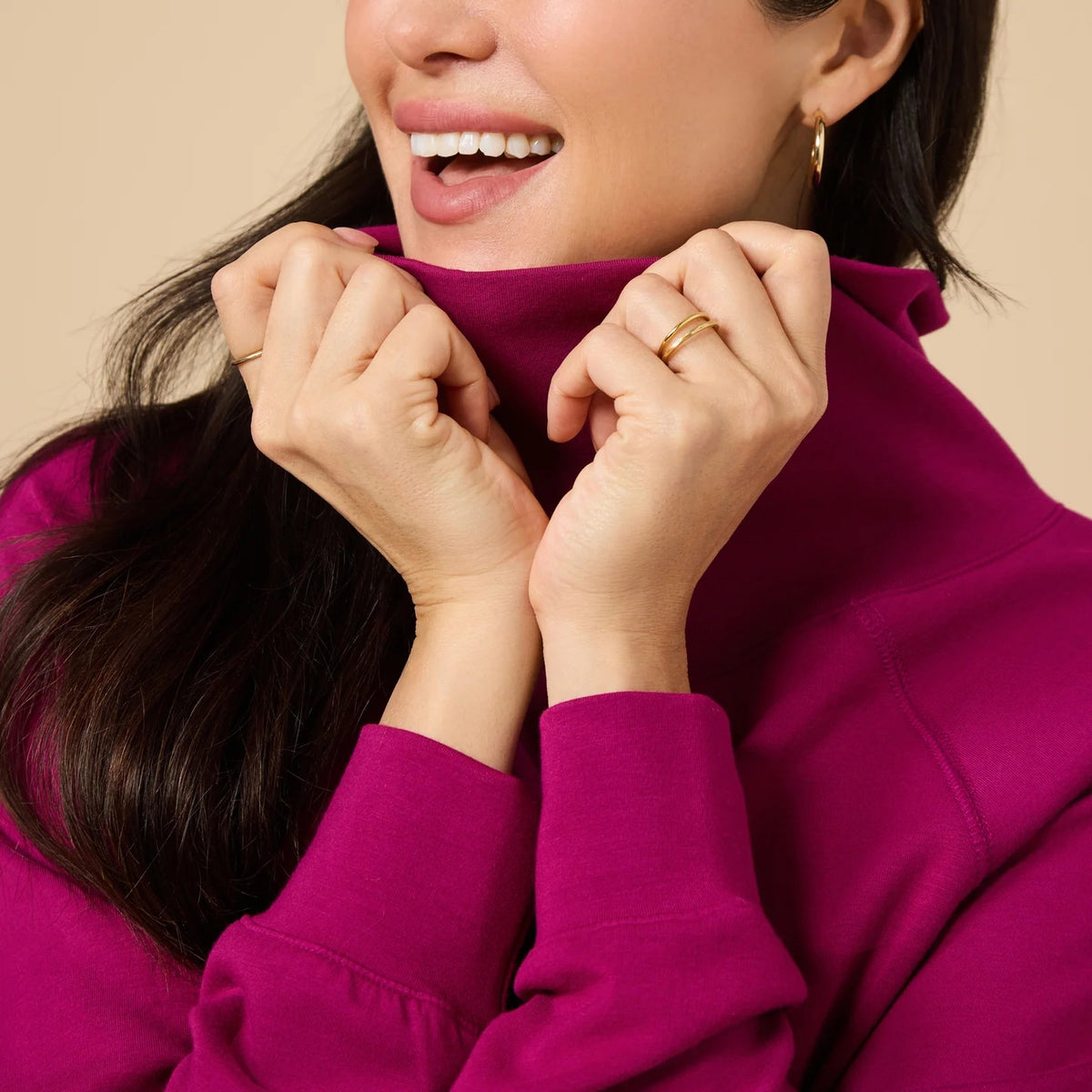 A woman seen from behind wearing the fuchsia SOFTIES - DREAMTECH COWL NECK WITH PLEATED PANT set featuring a long-sleeved cowl neck top and matching pleated pants.