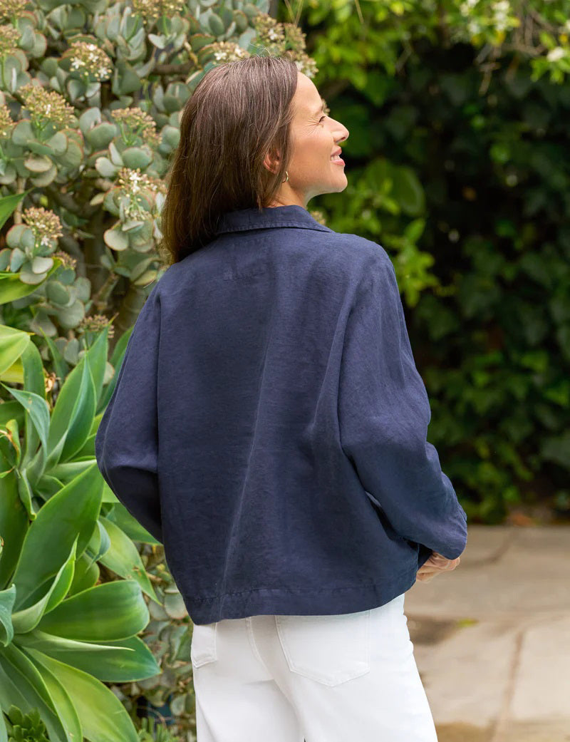 The FRANK &amp; EILEEN Gabi Popover Shirt in Linen Navy is a flowy, feminine top with bracelet-length sleeves and a wide open collar, no visible buttons, shown laid flat on a white background.