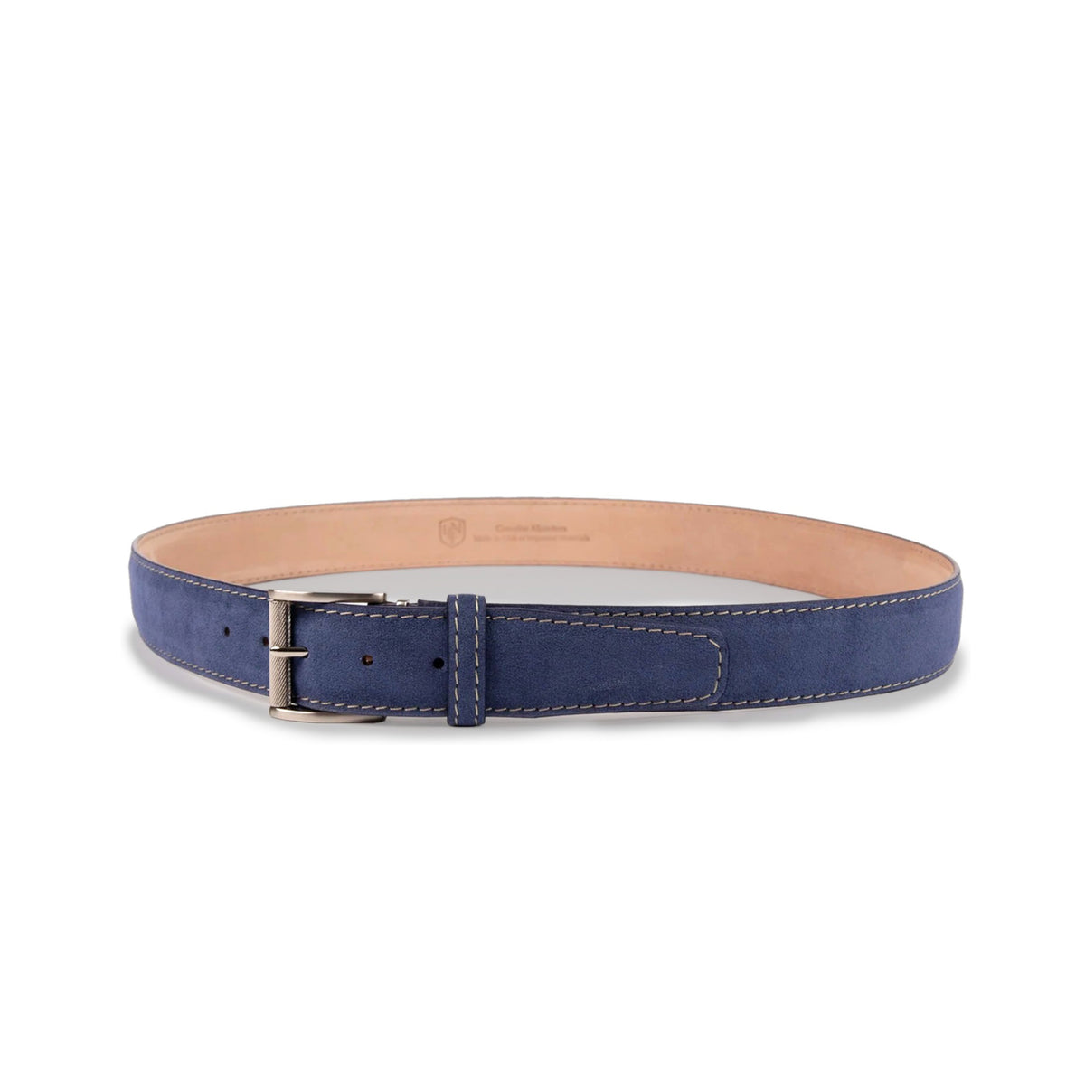 The LEN LIFESTYLE L.E.N. LIFESTYLE - ALCANTARA BELT IN BLUE JEAN features blue suede, white stitching, a silver buckle, and tan lining, displayed in a circular shape on a white background.