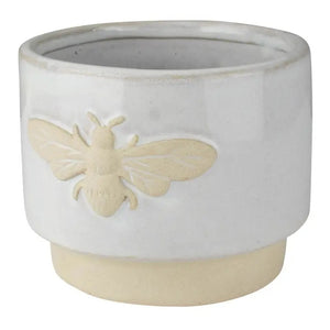 The HOMART CERAMIC BEE CACHEPOT is a charming 4" white ceramic planter with a beige base and a raised bee icon on the front.