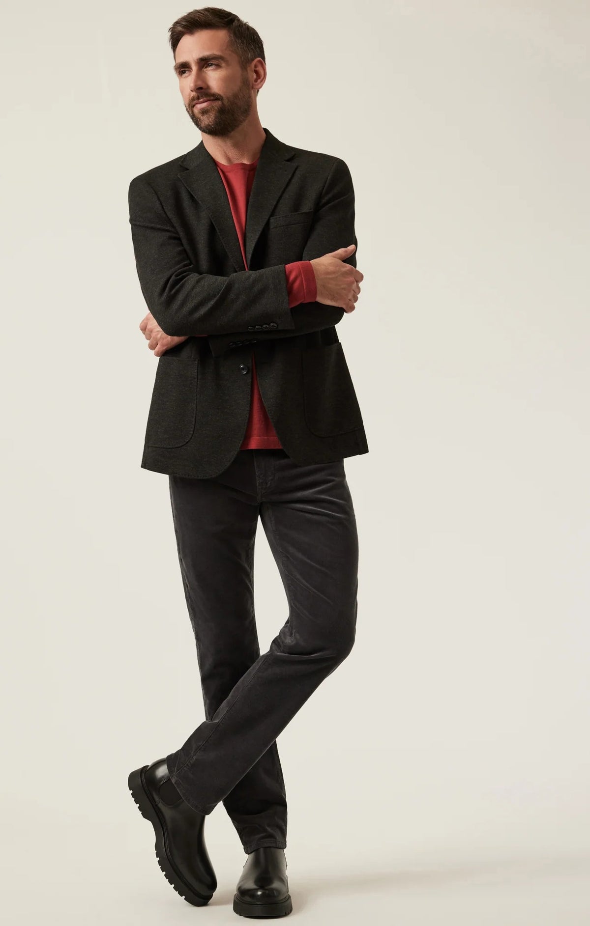 34 HERITAGE - CHARISMA RELAXED STRAIGHT LEG CORDUROY PANTS IN CHARCOAL worn with a red long-sleeve shirt and black leather boots.