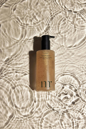 A Molovany Hypoallergenic LHA C18 Gel Cleanser bottle from Hong Cheon USA, Inc. features a black pump, light brown gel with darker specks for pore and dead skin cell reduction, and a label with black text.