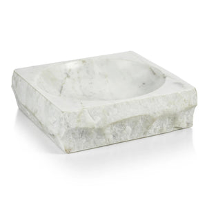 The ZODAX ROCK FINISH MARBLE SQUARE BOWL rests on a closed beige hardcover book, "AD at 100," atop a light wood surface.