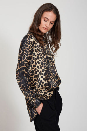 The 0039 ITALY - ALISAR BLOUSE showcases an elegant stand-up collar and long sleeves, highlighted by a striking black and tan leopard print, beautifully set against a plain gray background.