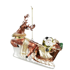 Creative Co-op Hand-Painted Glass Santa’s Sleigh and Reindeer Ornament with glitter, showing Santa in a sleigh being pulled by a reindeer.