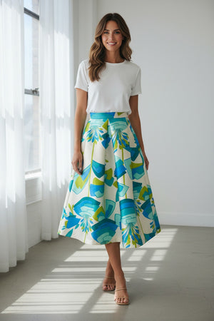 The MIDI STRUCTURED SKIRT by ALYKI LABORATORIO is a high-waisted, midi-length piece with a flared silhouette, showcasing a vibrant pink and red abstract floral print on a white background.