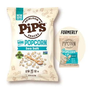 A bag of PIPCORN - SEA SALT POPCORN shown next to a smaller, older version of the PIP’S HEIRLOOM SNACKS packaging.