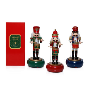 The ZODAX NUTCRACKER MELODY MUSIC BOX features festive nutcrackers in assorted styles, each with unique accessories. Sold individually; call store for details. Each stands next to a tall red gift box with a green and gold label.