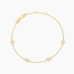 The ELLA STEIN - YOU ARE MY SUNSHINE BRACELET by ELLA STEIN is a delicate gold-plated piece featuring three small star-shaped charms on a fine chain with a lobster clasp closure, beautifully displayed on a white background.