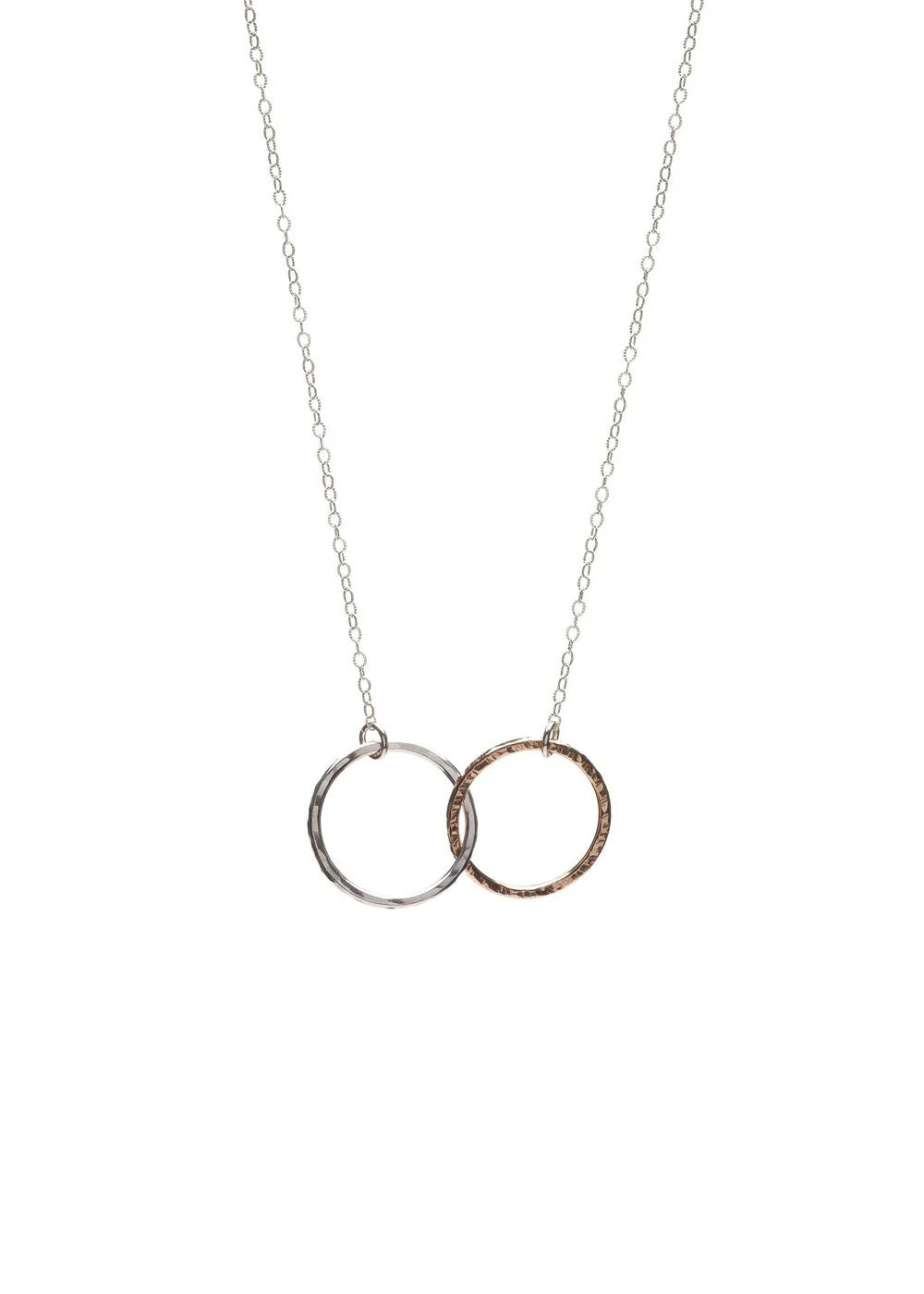 A close-up of KENDA KIST - THE BFF NECKLACE by KENDA KIST, a stunning two-tone interlocking circle necklace, perfect for celebrating friendship.