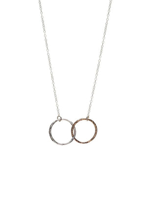 A close-up of KENDA KIST - THE BFF NECKLACE by KENDA KIST, a stunning two-tone interlocking circle necklace, perfect for celebrating friendship.