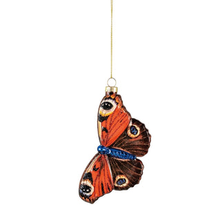 A Creative Coop hand-painted mercury glass butterfly ornament with glitter, featuring orange and brown wings with eye-spot patterns.