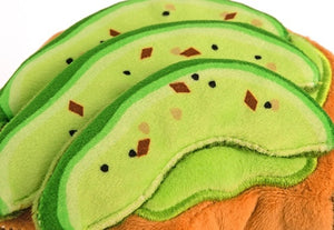 Introduce your pup to the BARKING BRUNCH - AVO-DOGGO TOAST by PLAY PET LIFESTYLES/BRANDS—a durable dog toy shaped like a slice of toast, topped with three avocado slices and decorated with embroidered seeds and seasoning. Perfect for playful pups who love dog brunch toys, it’s also machine washable for easy cleaning.