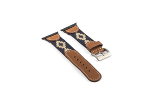 The LA MATERA CORBINA Apple Watch Band in Space Black features a rectangular screen and artisan-crafted brown leather strap with a black woven band adorned with tan diamond patterns, showcasing elegance on a crisp white background.