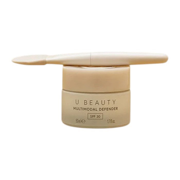 THE BRUSH by U BEAUTY is a white silicone skincare applicator featuring a flat, rounded tip and &quot;U BEAUTY&quot; on the handle—crafted for precision application against a clean, white background.