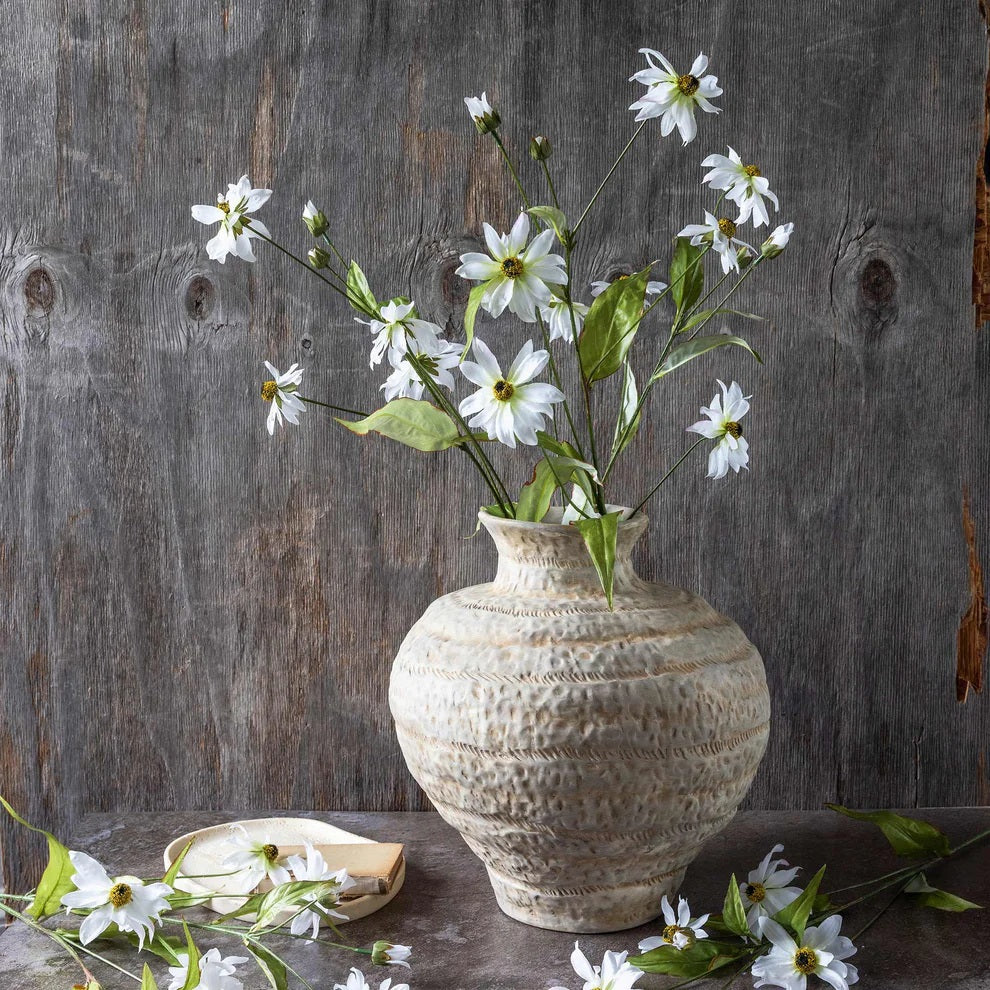 The ABIGAIL AHERN - WILD COSMOS botanical stem features green leaves and small white blossoms, creating a meadow-inspired silhouette against a plain white background.
