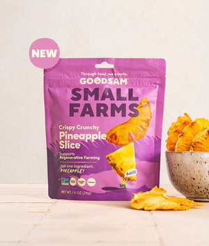 A pink pouch labeled "GOODSAM-PINEAPPLE FRUIT CHIPS" by GOODSAM FOODS shows pineapple rings. This vegan, keto, and baked snack supports regenerative farming and contains only pineapple.