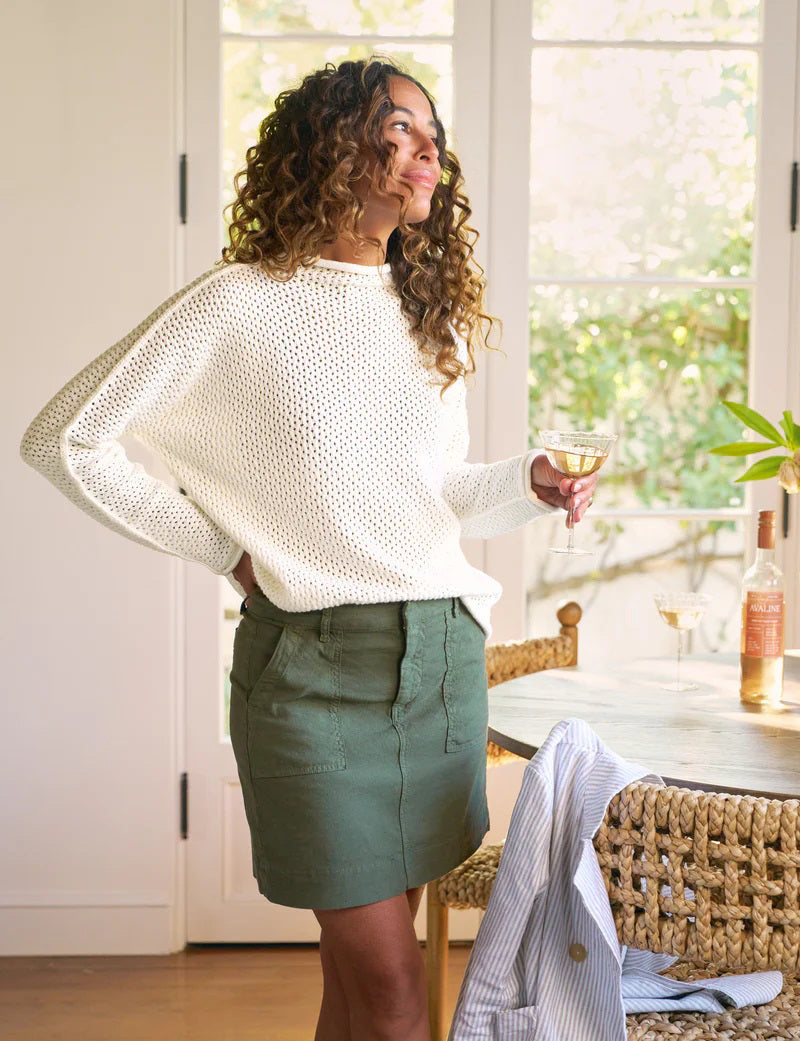 The FRANK &amp; EILEEN Jameson Utility Skirt in Hunter Green, knee-length and made of Italian Performance Linen, features utility pockets, belt loops, and visible stitching. Shown laid flat on a white background.