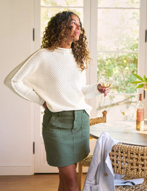 The FRANK & EILEEN Jameson Utility Skirt in Hunter Green, knee-length and made of Italian Performance Linen, features utility pockets, belt loops, and visible stitching. Shown laid flat on a white background.