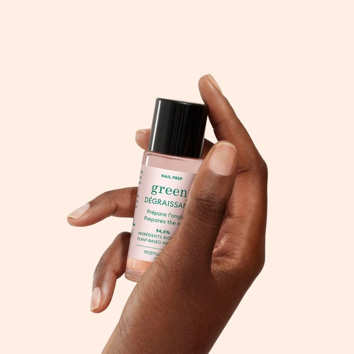 A 30ml bottle of MANUCURIST - GREEN™ DEGREASER nail prep from MANUCURIST INC, formulated with gentle, effective plant-based ingredients. The clear bottle features a black cap and a white label with green and black text.