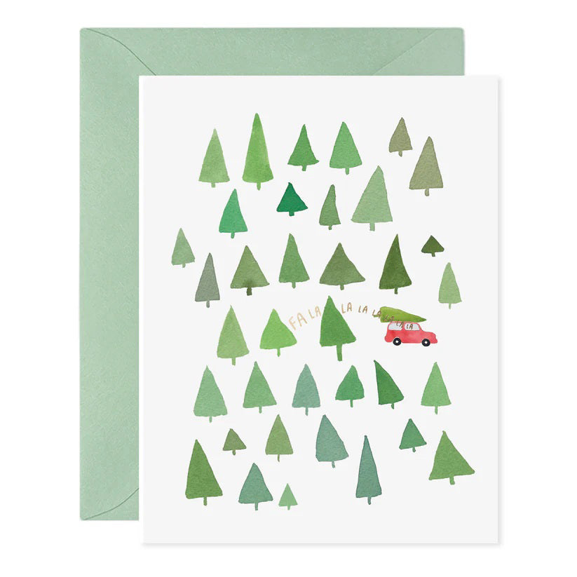 The FA LA LA LA LA TREES HOLIDAY CARD from E.FRANCES PAPER is a handcrafted watercolor greeting card featuring green trees and a small red car, with the phrase &quot;Fa la la la la&quot; among the foliage. Made in the USA, this festive Christmas card comes with a light green envelope, making it perfect for spreading holiday cheer.