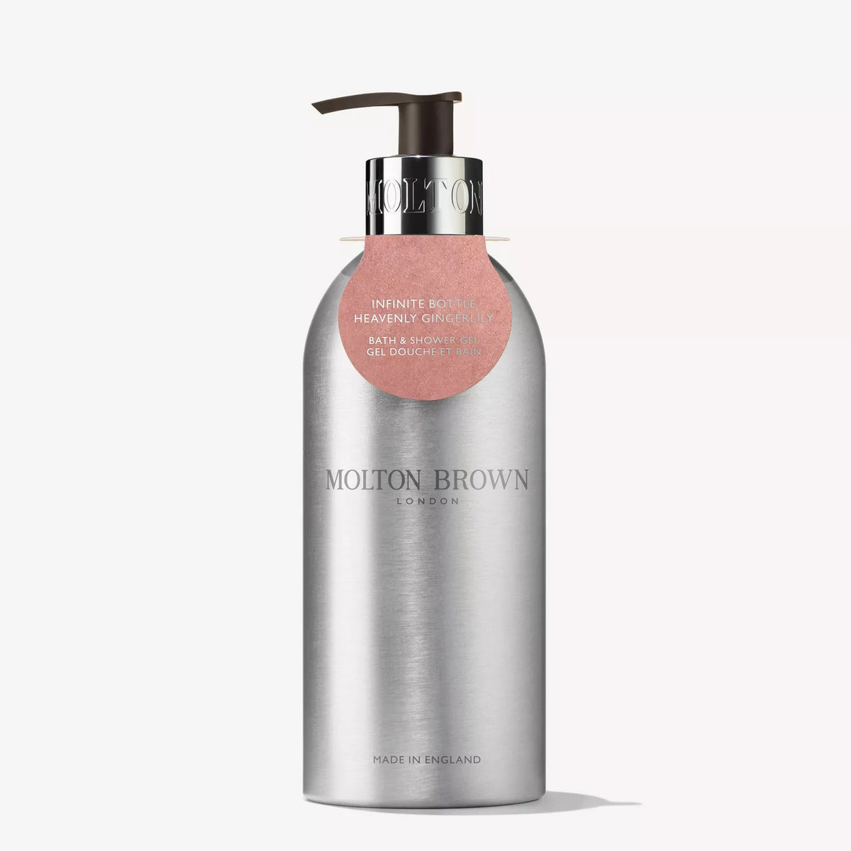 A silver recycled aluminium Molton Brown Gingerlily Body Wash Infinite Bottle with a black pump and round pink label—a plastic-saving refill for your white floral body wash ritual.