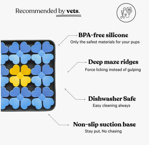 The BARKS & BROWNIES SNUFFLE MAT BOWL - BLUE features a tray with twelve four-petal flower shapes—ten in blue and two in yellow, with the yellow flowers placed at the center—all crafted from food-grade silicone for safe use as a dog slow feeder or snuffle mat bowl.