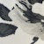 Inspired by the MILVA MI COTTON DRESS WITH A BLACK AND WHITE FLORAL PRINT, this abstract painting features bold, textured brushstrokes echoing floral petals and leaves on a soft background. Brand: MILVA.
