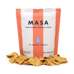 A bag of ANCIENT CRUNCH - TRADITIONAL TORTILLA CHIPS by ANCIENT CRUNCH with red and white stripes stands upright, labeled "Original" and "No Seed Oils," highlighting its seed oil-free recipe with crunchy chips scattered in front.