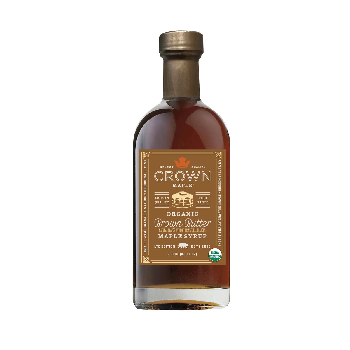 A bottle of CROWN MAPLE - BROWN BUTTER ORGANIC MAPLE SYRUP from the CROWN MAPLE brand, featuring a brown label with a gold cap, product details, and an organic certification badge.