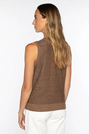 A woman with long, light brown hair smiles in the KINROSS CASHMERE - OPEN TEXTURE LUREX LINEN TANK and white pants, standing against a plain white background.