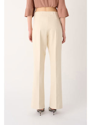 Back view of a person wearing a mauve, short-sleeved top and MEIMEIJ - PULL ON PANT IN SUGAR SWIZZLE, which are cream-colored, flared-leg trousers designed for tailored comfort.