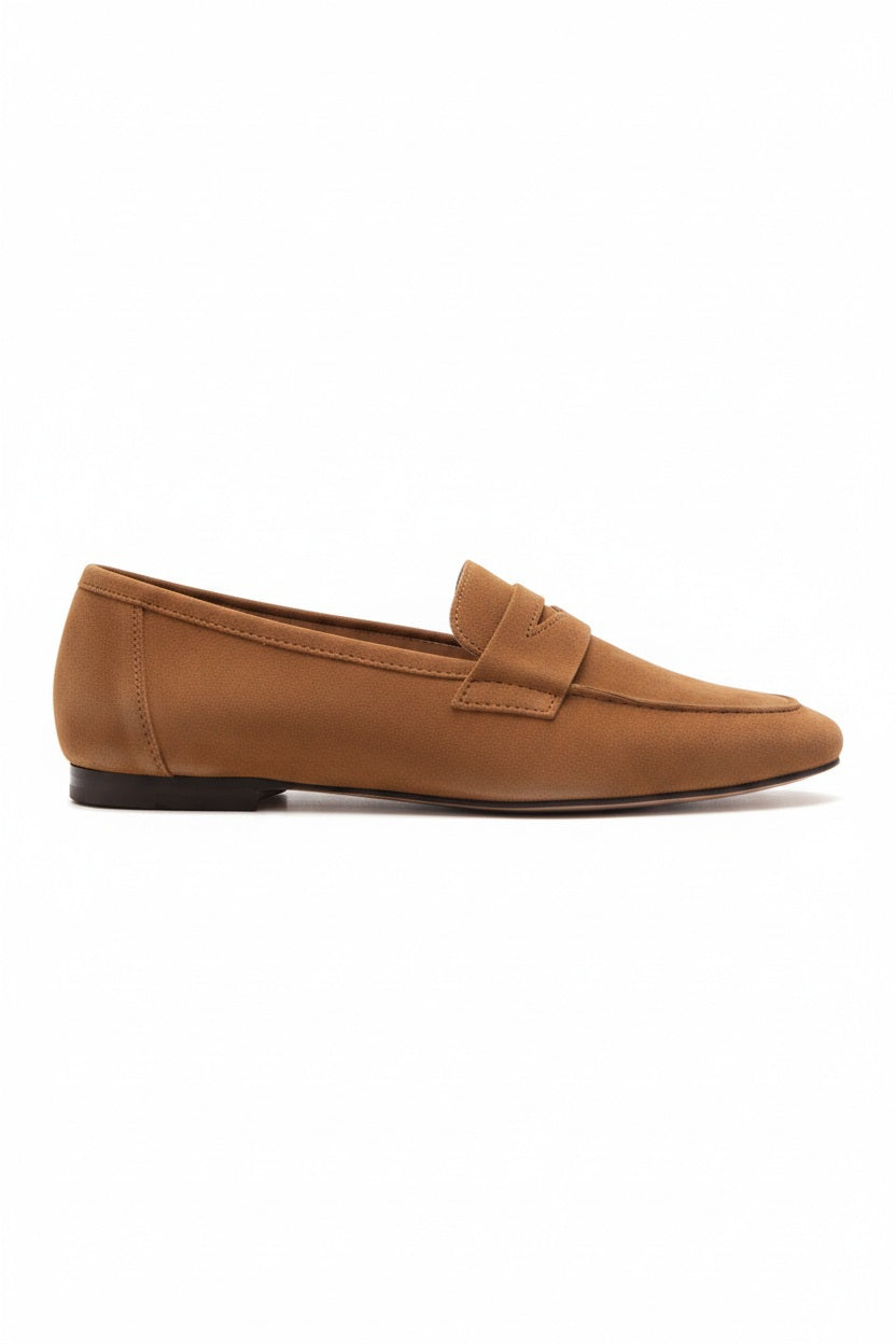 The MICHELE LOPRIORE - PAOLA SUEDE LOAFER is a light brown suede moccasin loafer with a low heel and decorative strap, displayed against a plain white textured background.