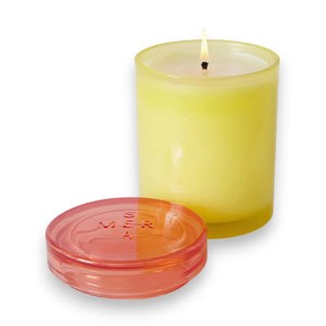 The MERSEA - FRESH CITRON JOLIE JAR CANDLE, a yellow soy wax blend candle with a pink-tinted lid from MERSEA, is displayed against a white background.