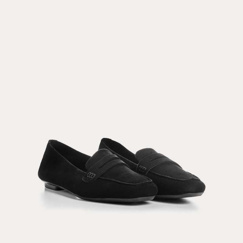 The REQINS HEMA Suede Loafer in Noir features a classic black silhouette, low heel, leather insole, and decorative front strap, shown against a plain light background.