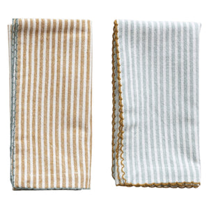 The CREATIVE COOP STRIPED COTTON NAPKIN WITH SCALLOP TRIM comes in aqua or mustard. Each 18" reusable napkin adds a stylish touch to your table linens collection.