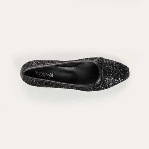 A single REQINS - FETICHE GLITTER HEELED BALLERINA shoe, black and covered in glitter, viewed from above with a small bow on the toe and "REQINS" on the insole—perfect elegant party shoes.