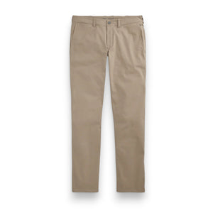The MACK WELDON - MAVERICK TECH CHINO is a beige, stain-resistant pair of chinos with a straight-leg cut, button closure, and side pockets, shown laid flat on a white background.