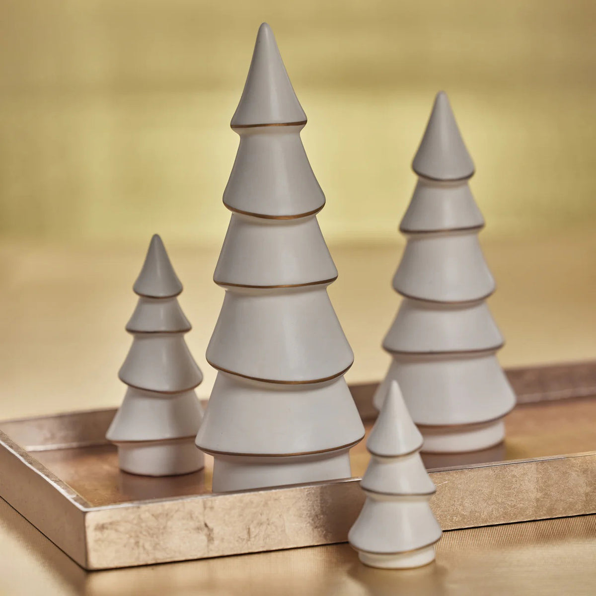 The ZODAX Alpina White Porcelain Tree with Gold Trim (8.5&quot;) features five minimalist tiered layers, standing elegantly upright and showcasing refined, modern holiday style.