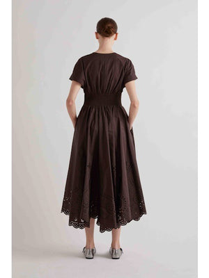 A solid brown square evokes the minimalist style of the MEIMEIJ V Neck Laser Cut Dress by MEIMEIJ—understated and elegant.