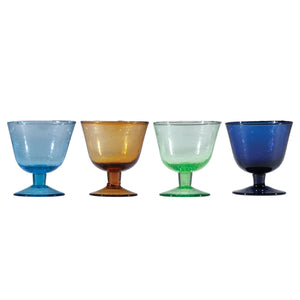 The HAND-BLOWN STEMMED SEEDED GLASS by CREATIVE COOP is a green-tinted goblet with a wide bowl, short stem, and round base. Its hand-blown seeded glass features visible bubbles and a gradient with richer green at the bottom.